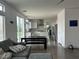 Open-concept living room and kitchen featuring modern finishes, stainless steel appliances, and ample natural light at 10650 Robin Hill Ave, Las Vegas, NV 89129
