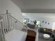 Spacious staircase with white railings leading to the well-lit living area at 10650 Robin Hill Ave, Las Vegas, NV 89129