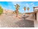 Low-maintenance backyard with desert landscaping and covered patio area at 1108 Sidehill Way, Las Vegas, NV 89110