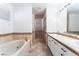 Bright bathroom features double sink vanity, soaking tub, and a walk-in glass enclosed shower at 1108 Sidehill Way, Las Vegas, NV 89110