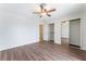 Bedroom features hardwood floors, ceiling fan, and mirrored sliding closet doors at 1108 Sidehill Way, Las Vegas, NV 89110