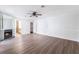 Primary bedroom boasts wood-look floors, a ceiling fan, fireplace, and ensuite bathroom and closet at 1108 Sidehill Way, Las Vegas, NV 89110