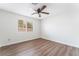 Bedroom with hardwood floors, window, and ceiling fan at 1108 Sidehill Way, Las Vegas, NV 89110