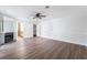 Primary bedroom boasts wood-look floors, a ceiling fan, fireplace, and ensuite bathroom and closet at 1108 Sidehill Way, Las Vegas, NV 89110
