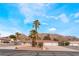 Expansive single-story home with lush landscaping, circular driveway, and mountain views at 1108 Sidehill Way, Las Vegas, NV 89110