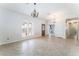Bright, spacious living room with arched windows and tile flooring, leading to an adjoining hallway at 1108 Sidehill Way, Las Vegas, NV 89110