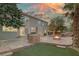 Backyard with a large outdoor grill, swimming pool with slide and waterfall, fire pit, and palm trees at 11158 Antonine Wall Ct, Las Vegas, NV 89141