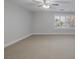 Bright main bedroom with large window offering views, neutral carpet, and ceiling fan at 11158 Antonine Wall Ct, Las Vegas, NV 89141