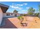 Spacious backyard with gravel, concrete patio, and desert landscaping at 1202 Arrowhead Ave, Las Vegas, NV 89106