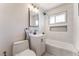 Bathroom features white vanity with black hardware and tiled shower with recessed shelf at 1202 Arrowhead Ave, Las Vegas, NV 89106