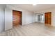 Bright bedroom featuring light wood floors, large mirrored closets, and wood-lined walk in closet at 1202 Arrowhead Ave, Las Vegas, NV 89106
