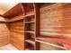 Walk-in closet with rich wood paneling, shelving, and hanging rods at 1202 Arrowhead Ave, Las Vegas, NV 89106