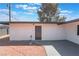 View of home exterior, gravel, concrete patio, and desert landscaping at 1202 Arrowhead Ave, Las Vegas, NV 89106