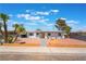 Charming single-story home with desert landscaping, vibrant curb appeal, and a welcoming yellow front door at 1202 Arrowhead Ave, Las Vegas, NV 89106