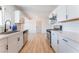 Bright kitchen with modern appliances, white cabinetry, and a sleek black faucet overlooking the backyard at 1202 Arrowhead Ave, Las Vegas, NV 89106
