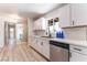 Well-lit kitchen boasting white cabinets, a stainless steel dishwasher, and sleek countertops at 1202 Arrowhead Ave, Las Vegas, NV 89106