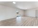 Bright room featuring wood-look floors, neutral walls, and sliding glass doors to a backyard at 1202 Arrowhead Ave, Las Vegas, NV 89106