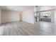Open-concept living room featuring light, neutral walls and floors, seamlessly connecting to an updated kitchen at 1202 Arrowhead Ave, Las Vegas, NV 89106