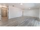 Bright living room featuring wood-look floors, neutral walls, and open access to other rooms at 1202 Arrowhead Ave, Las Vegas, NV 89106