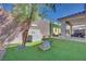 This backyard features artificial turf, a dog wash, and a comfortable seating area at 1208 Crimson Sunbird St, North Las Vegas, NV 89084