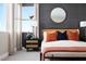 This bedroom has modern decor, large window with beautiful lighting, and stylish accents at 1208 Crimson Sunbird St, North Las Vegas, NV 89084