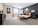 This spacious bedroom features contemporary decor, and large windows allowing for ample natural light at 1208 Crimson Sunbird St, North Las Vegas, NV 89084
