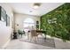 Unique office space featuring an accent wall with plants, modern furniture, and lots of light at 1208 Crimson Sunbird St, North Las Vegas, NV 89084