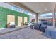 This outdoor patio includes a built-in barbecue, an outdoor dining set, and comfortable seating at 1208 Crimson Sunbird St, North Las Vegas, NV 89084