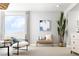 A sitting area in a bedroom features a bench seat and chairs, an abstract art print, and a nice plant at 1212 Crimson Sunbird St, North Las Vegas, NV 89084
