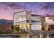 Modern two-story home featuring stylish architecture and well-manicured landscaping against a stunning sunset backdrop at 1212 Crimson Sunbird St, North Las Vegas, NV 89084