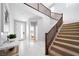 Bright foyer showcasing marble floors, a staircase with wood railings, and an open view to the bedroom at 1212 Crimson Sunbird St, North Las Vegas, NV 89084