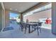 Covered outdoor dining area with outdoor kitchen/BBQ with privacy walls and an adjacent lounge area with firepit at 1212 Crimson Sunbird St, North Las Vegas, NV 89084