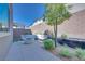 This outdoor seating area has sleek outdoor furniture, a fire pit, and a privacy wall for relaxing outdoors at 1212 Crimson Sunbird St, North Las Vegas, NV 89084