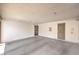 An empty covered parking area featuring two doors, one with a metal security screen and concrete flooring at 1553 Dorothy Ave # 4, Las Vegas, NV 89119