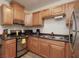 A kitchen featuring wood cabinets and stainless steel appliances at 1553 Dorothy Ave # 4, Las Vegas, NV 89119