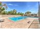 Community pool featuring cool, clear water, a paved deck, and comfortable lounge chairs for relaxing at 1553 Dorothy Ave # 4, Las Vegas, NV 89119
