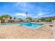 Beautiful community pool with a brick paver deck and clear blue water, surrounded by lush landscaping at 1553 Dorothy Ave # 4, Las Vegas, NV 89119