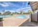 An in-ground neighborhood swimming pool and tennis court area with a brick deck and perimeter fencing at 1553 Dorothy Ave # 4, Las Vegas, NV 89119