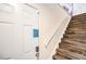 Hallway with wood stairs, handrail, and a door at 1553 Dorothy Ave # 4, Las Vegas, NV 89119