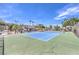 Community tennis court with a blue playing surface and lush green surroundings on a sunny day at 1553 Dorothy Ave # 4, Las Vegas, NV 89119