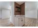 Stylish bar area featuring wood paneling, floating shelves, a marble countertop, and white cabinetry at 1808 E Saint Louis Ave, Las Vegas, NV 89104