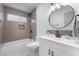 Updated bathroom with white vanity, new fixtures, and shower-over-tub at 1808 E Saint Louis Ave, Las Vegas, NV 89104