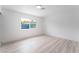 Bright bedroom with white walls, light wood floors, and a window with natural light at 1808 E Saint Louis Ave, Las Vegas, NV 89104