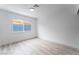 Light-filled bedroom featuring white walls, light wood floors, and a window at 1808 E Saint Louis Ave, Las Vegas, NV 89104