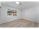 Bright bedroom with light wood floors and a window overlooking the neighborhood at 1808 E Saint Louis Ave, Las Vegas, NV 89104