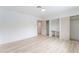 Spacious bedroom with light wood floors, closet, and entry door at 1808 E Saint Louis Ave, Las Vegas, NV 89104