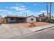 Charming single-story home with tidy landscaping, gray exterior and driveway at 1808 E Saint Louis Ave, Las Vegas, NV 89104