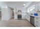 Modern kitchen with white cabinets, stainless steel appliances, and light wood flooring at 1808 E Saint Louis Ave, Las Vegas, NV 89104