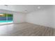 Bright living room featuring light wood flooring and a sliding glass door leading to the outdoor pool at 1808 E Saint Louis Ave, Las Vegas, NV 89104