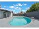 Backyard pool provides a nice place to cool off with an outside seating area and a dark gray block wall at 1808 E Saint Louis Ave, Las Vegas, NV 89104